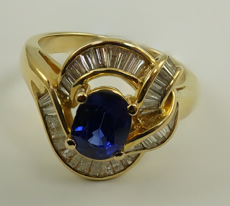 A modern 18k gold, sapphire and diamond cluster set dress ring